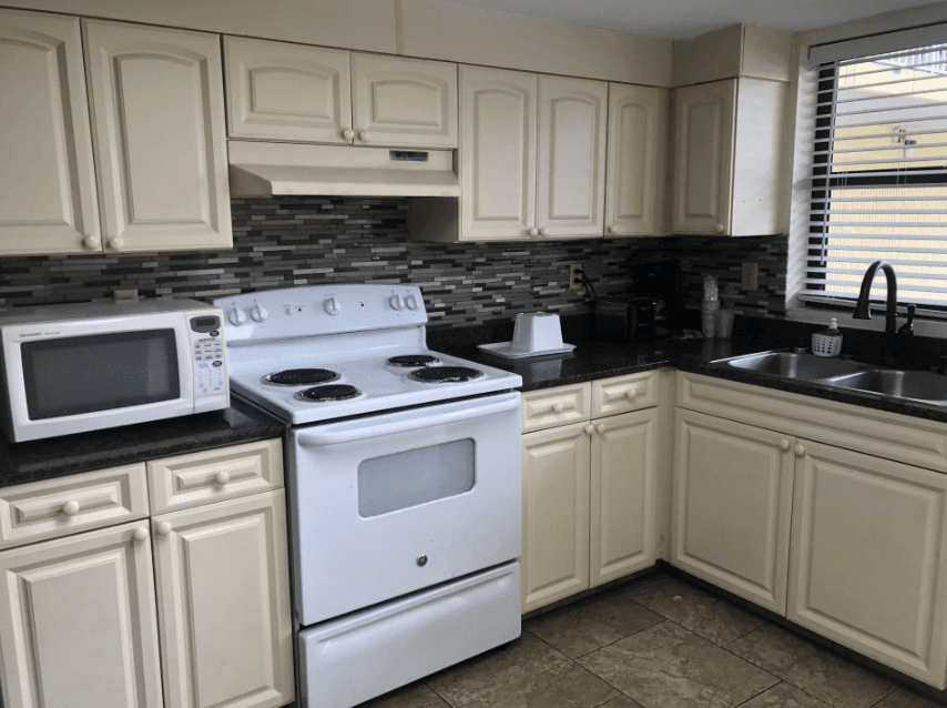 Full kitchen with a range, microwave, and sink in the two-bedroom apartment