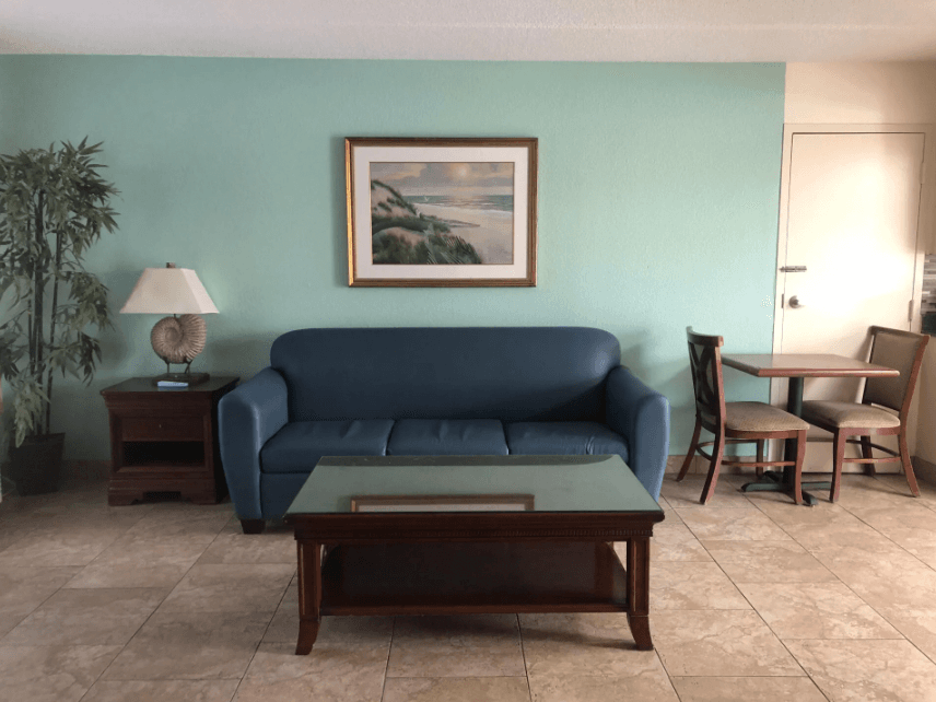 Living area with a sofa and dining table in the two-bedroom apartment